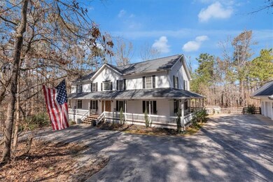Farmhouse featuring driveway and a porch