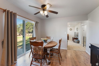 Dining room featuring light wood-style floors and a ceiling fan