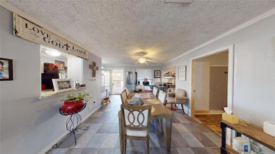 Dining room with a textured ceiling, ceiling fan, 