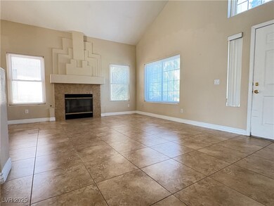 Unfurnished living room featuring high vaulted cei