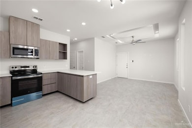 Kitchen with appliances with stainless steel finishes, modern cabinets, a peninsula, open shelves, and recessed lighting