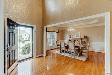 At the front door is an elegant two story foyer wi