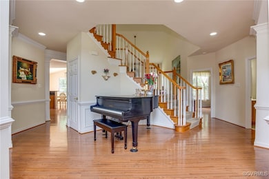 Foyer entrance featuring stairs, light wood-style