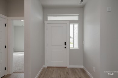 Foyer featuring baseboards and light wood-style floors