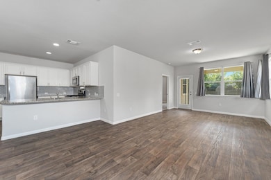 Unfurnished living room with dark wood finished f