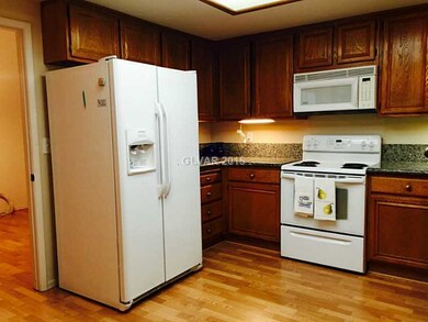 Kitchen. Granite counters, clean white appliances,