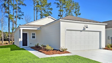 Single story home featuring a garage and a front l