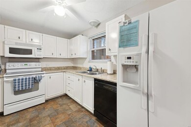 Kitchen offers lots of cabinet space, pantry and r