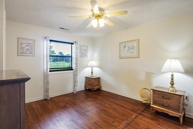 Sitting room with dark hardwood / wood-style floor