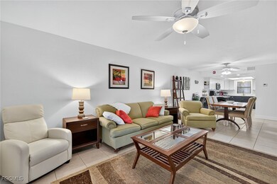 Living area with light tile patterned floors and a ceiling fan