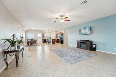 Living room featuring a ceiling fan, light tile p
