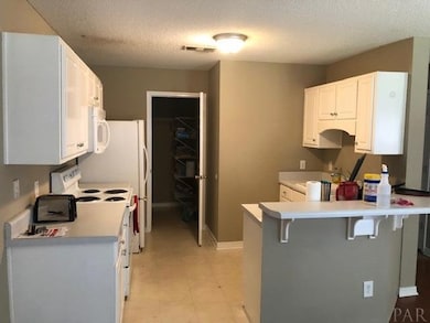 Kitchen with door to laundry room and garage door.
