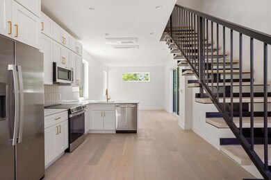 Kitchen with tasteful backsplash, baseboards, lig