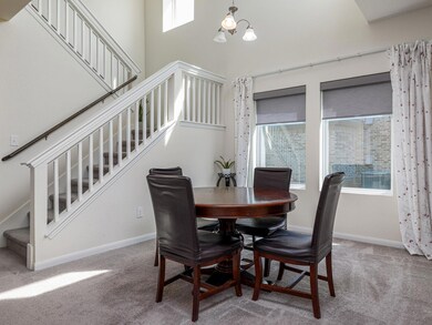 Carpeted dining space with stairway, a high ceili
