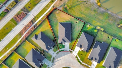 Expansive lot with stunning lake views, featuring wrought-iron fencing on two sides.