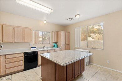 Kitchen featuring black dishwasher, light countert