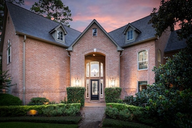 This beautiful two-story brick home has a grand, w