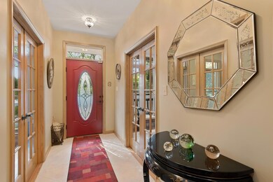 Foyer with beautiful hickory floors & transom window