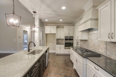 Beautiful custom cabinetry features soft close drawers. Granite countertops!