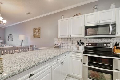 Kitchen with hanging light fixtures, a chandelier,