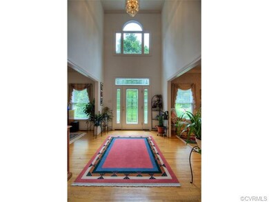 Grand 2 story foyer with gleaming hardwood floors 