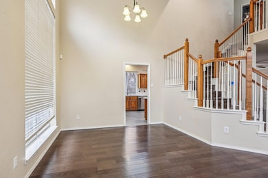 Unfurnished living room with a high ceiling, stair