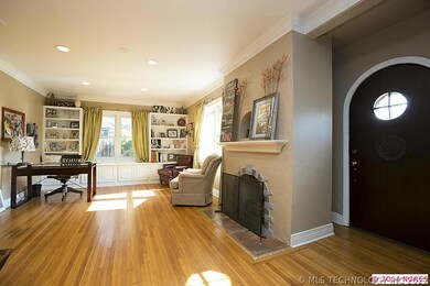 Enter through a classic arched wood front door to