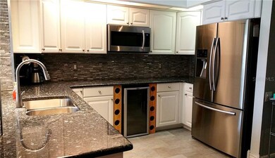 NICELY APPOINTED KITCHEN WITH STAINLESS STEEL, GRANITE AND TILE FINISHES. ALSO A GREAT WINE COOLER.