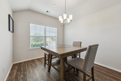This photo showcases a bright dining room with a w
