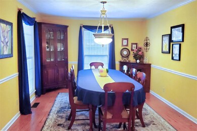 A formal dining room and living room combo are ope