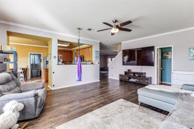 Living area with a ceiling fan, wood finished flo