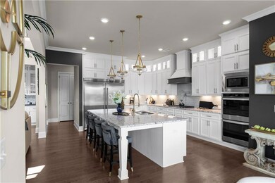 Kitchen with wall chimney exhaust hood, white cabi