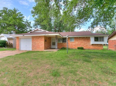 Single story home with a garage, a carport, and a 