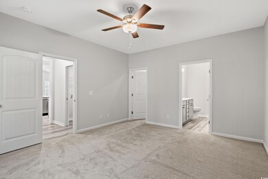 Unfurnished bedroom featuring ensuite bathroom, li