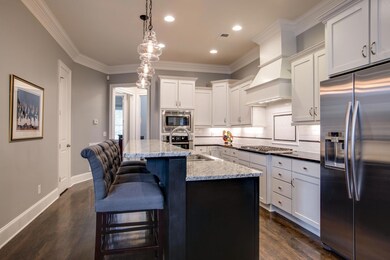 This Kitchen is gorgeous with great cabinet storage -notice the deep drawers on each side of cooktop. Decorative Hood, Undercabinet Lighting, Lazy Susan, Trash Pull-out and best of all, SOFT CLOSE Cabinet Drawers & Doors! Glass Pendant lighting.