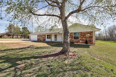 Ranch-style home featuring driveway, brick siding,