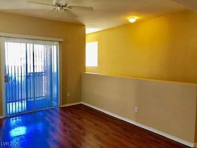 Spare room featuring dark wood-type flooring and a ceiling fan