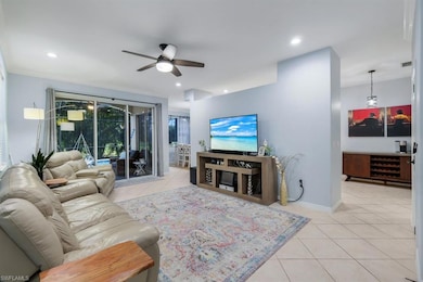 Tiled living room featuring ceiling fan