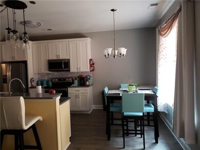 Kitchen featuring tasteful backsplash, white cabin