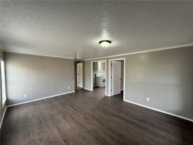 Spare room featuring a textured wall, a textured c
