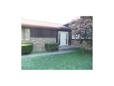 The manicured front walk leads to the entrance of 