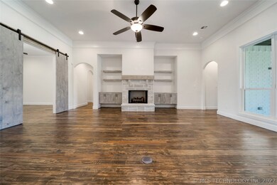 Family room. Built-ins flank stone fireplace.