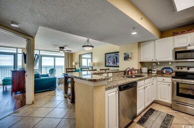 Kitchen featuring white cabinets, ceiling fan, kit