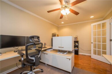 This first floor den offers crown moldings, recess