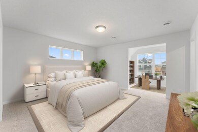 The private primary bedroom features an additional sitting space and 2 separate walk in closets!