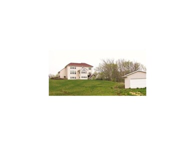Exterior Back. 1.3 acre yard sits high on a hillsi