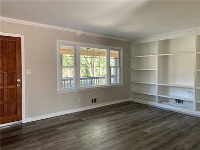 Spare room featuring baseboards, plenty of natural