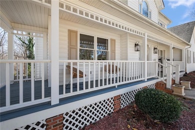 Doorway to property with a porch and a shingled ro