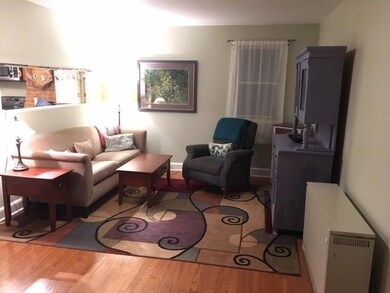 Large living area with hardwood floors.