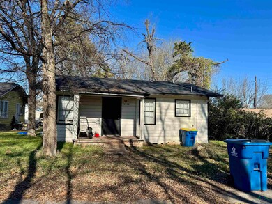 Back of house with a lawn